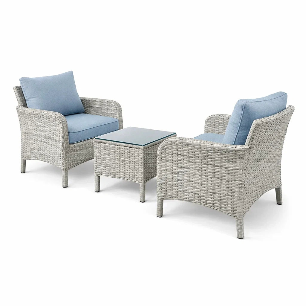 Set da giardino in rattan grigio con cuscini blu e tavolino in vetro temperato